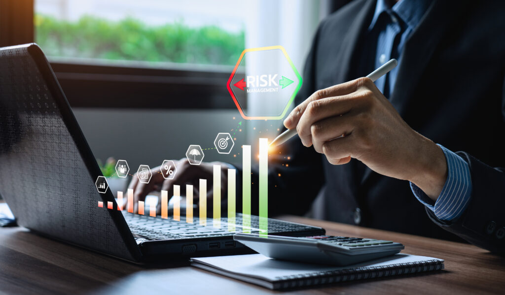 Businessman using digital pen on laptop with visualized bar chart and icons representing financial risk management, insurance, investment analysis, and strategic planning in modern fintech environment Fintech Calculator Development